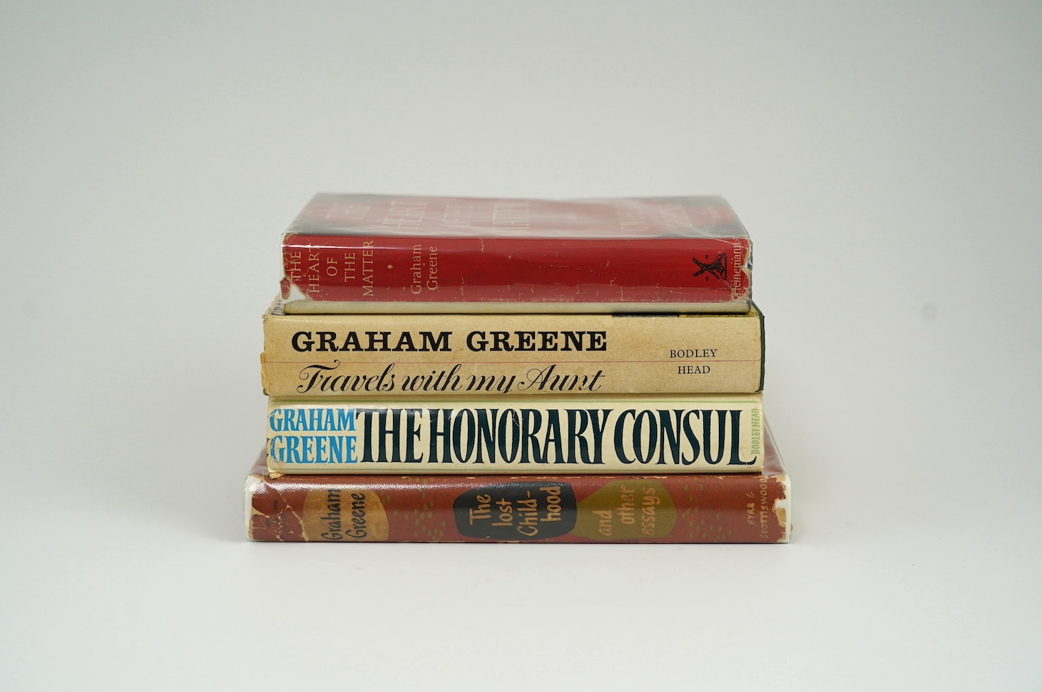 Greene, Graham - The Heart of the Matter, 1948. The Lost Childhood, 1951. Travels with my Aunt, 1969. The Honorary Consul, 1973, all 1st editions (4)